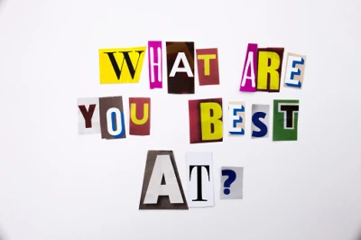 Colourful collage of cut-out letters on a white background forming the phrase 'What are you best at?'